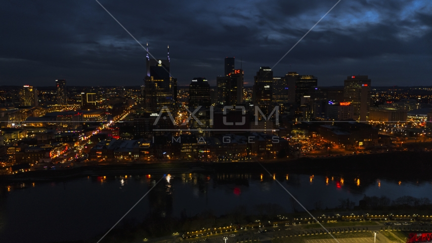 Tthe AT&T Building and skyline at twilight on the other side of the river, Downtown Nashville, Tennessee Aerial Stock Photo DXP002_121_0009 | Axiom Images