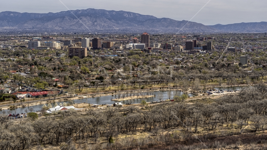 A wide view of high-rise office buildings seen from Tingley Beach, Downtown Albuquerque, New Mexico Aerial Stock Photo DXP002_124_0003 | Axiom Images