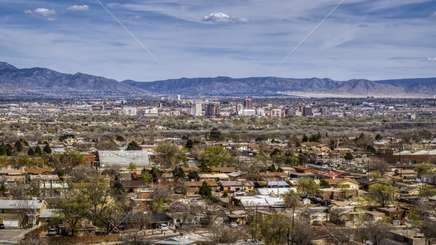 Suburban homes with a view of Downtown Albuquerque in the distance, New Mexico Aerial Stock Photo DXP002_126_0001 | Axiom Images