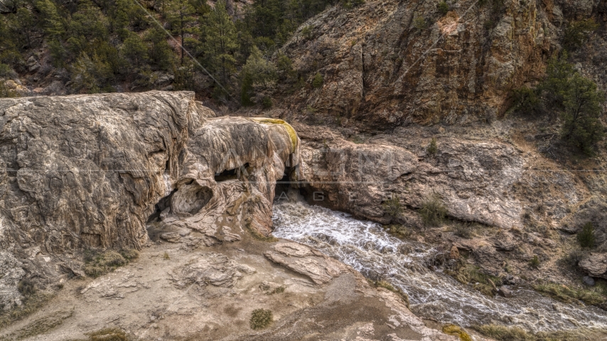 River rapids flowing through Soda Dam rock formation in the mountains in New Mexico Aerial Stock Photo DXP002_129_0004 | Axiom Images