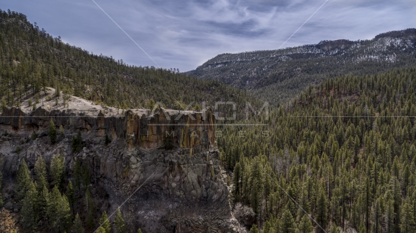 The side of a rock formation in the mountains in New Mexico Aerial Stock Photo DXP002_129_0009 | Axiom Images