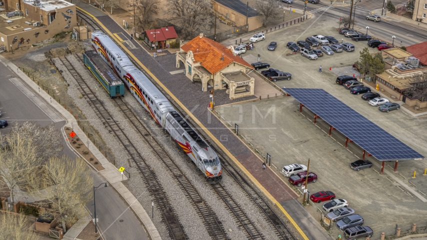 A view of a passenger train at the station in Santa Fe, New Mexico, tilt to top of the train Aerial Stock Photo DXP002_130_0008 | Axiom Images