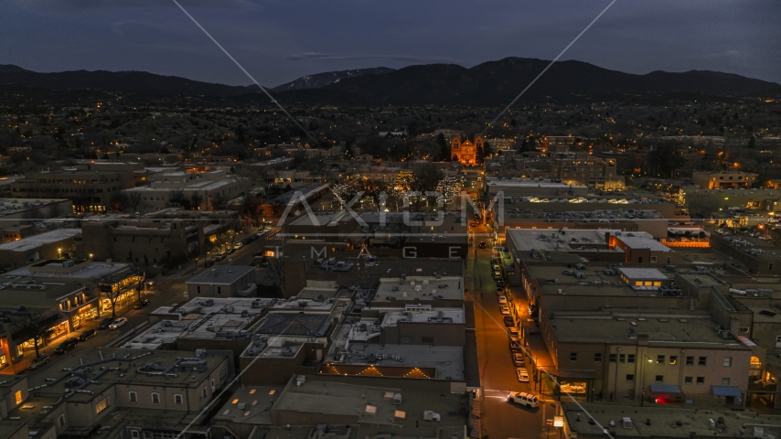 The cathedral lit up at night at the end of San Francisco Street, Santa Fe, New Mexico Aerial Stock Photo DXP002_132_0004 | Axiom Images