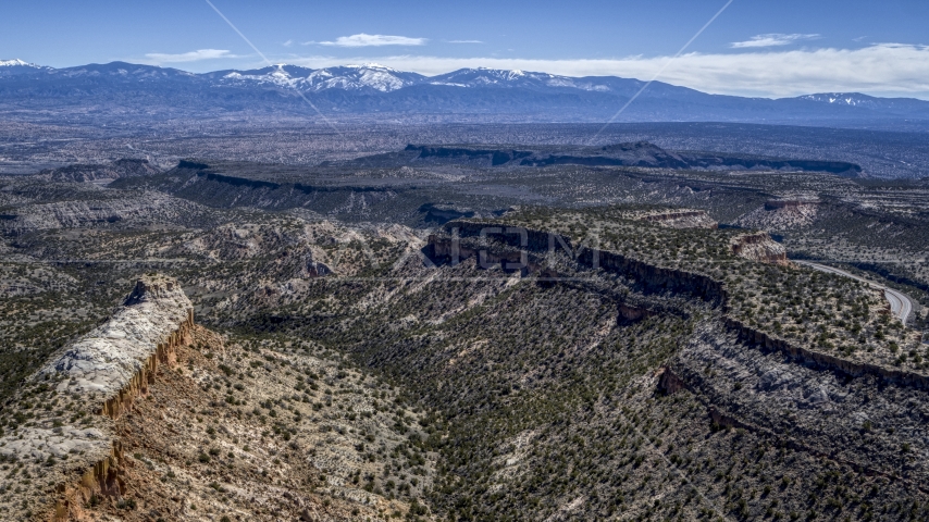 Flat desert mesas and distant mountains in New Mexico Aerial Stock Photo DXP002_133_0011 | Axiom Images