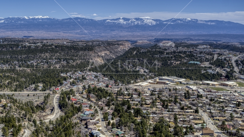 Distant mountains seen from neighborhoods near mesas and canyons in Los Alamos, New Mexico Aerial Stock Photo DXP002_134_0002 | Axiom Images