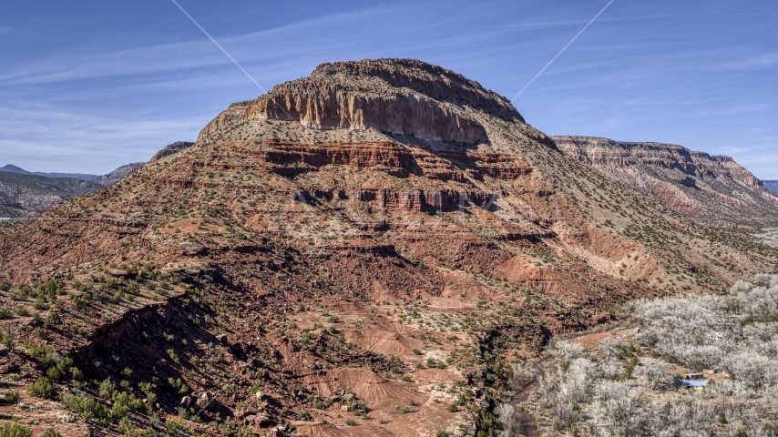 A tall, rugged butte in New Mexico Aerial Stock Photo DXP002_135_0003 | Axiom Images