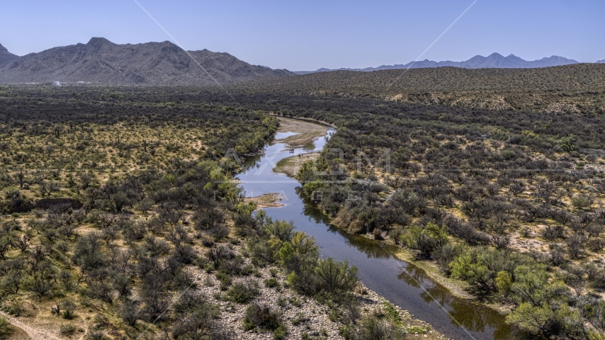 Horses at a shallow river through the desert Aerial Stock Photo DXP002_141_0001 | Axiom Images