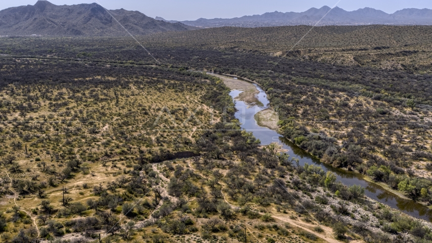 A view of a shallow river through the desert Aerial Stock Photo DXP002_141_0008 | Axiom Images