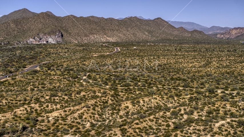 A desert road near mountains Aerial Stock Photo DXP002_141_0018 | Axiom Images