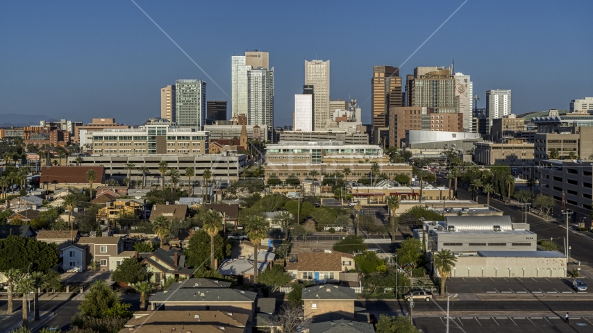 High-rise office buildings of the city's skyline at sunset in Downtown Phoenix, Arizona Aerial Stock Photo DXP002_143_0001 | Axiom Images