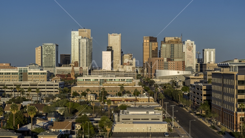 A view of high-rise office buildings of the city's skyline at sunset in Downtown Phoenix, Arizona Aerial Stock Photo DXP002_143_0002 | Axiom Images