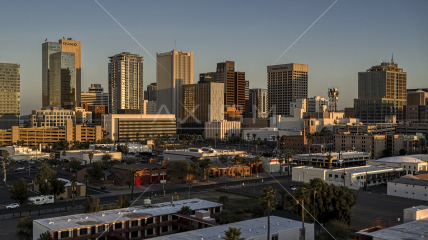 A view of the tall office buildings in the city's skyline at sunset, Downtown Phoenix, Arizona Aerial Stock Photo DXP002_143_0006 | Axiom Images