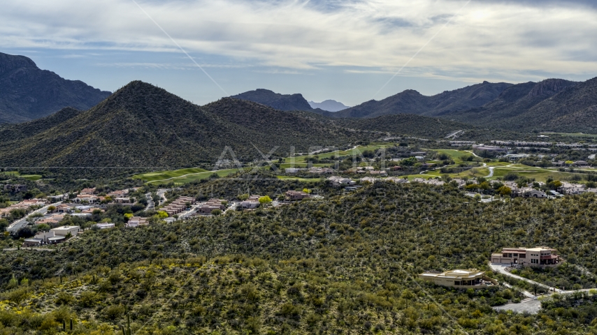 A view of homes and golf course near a mountain peak in Tucson, Arizona Aerial Stock Photo DXP002_145_0001 | Axiom Images