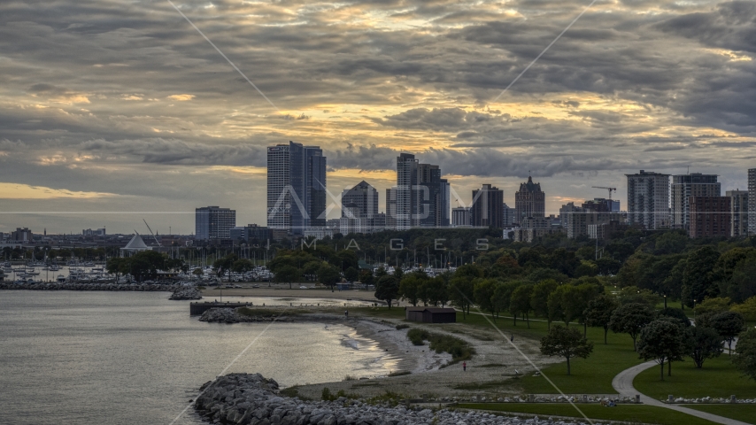 A beach and the city's skyline at twilight, Downtown Milwaukee, Wisconsin Aerial Stock Photo DXP002_155_0002 | Axiom Images
