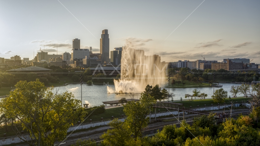 A view of a fountain with view of skyline at sunset, Downtown Omaha, Nebraska Aerial Stock Photo DXP002_172_0004 | Axiom Images