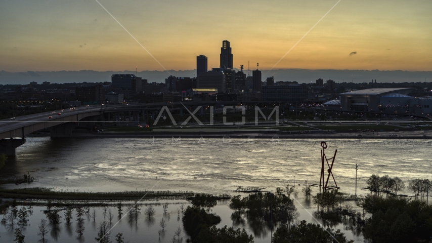 The skyline seen from the river at twilight, Downtown Omaha, Nebraska Aerial Stock Photo DXP002_172_0014 | Axiom Images