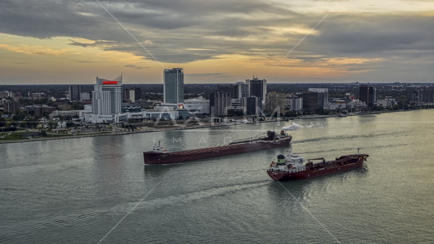 Oil tankers passing on the Detroit River near skyline of Windsor, Ontario, Canada, sunset Aerial Stock Photo DXP002_192_0010 | Axiom Images