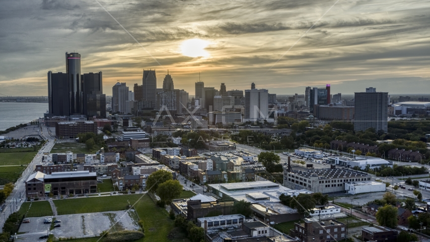 The setting sun behind clouds above the Downtown Detroit skyline, Michigan Aerial Stock Photo DXP002_197_0001 | Axiom Images