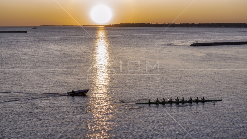 A view of Lake Erie as a rowboat and speedboat pass at sunset, Buffalo, New York Aerial Stock Photo DXP002_204_0005 | Axiom Images