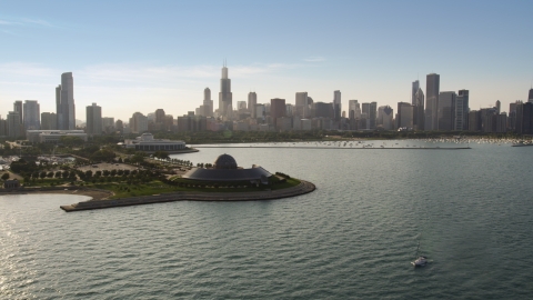 AX0001_099.0000279F - Aerial stock photo of Adler Planetarium and Downtown Chicago skyline seen from Lake Michigan, Illinois