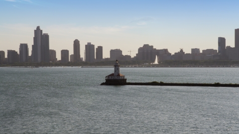AX0002_047.0000079F - Aerial stock photo of The Chicago Harbor Lighthouse with the Downtown Chicago skyline in the background, Illinois