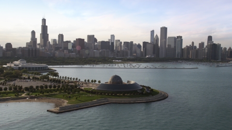 AX0002_086.0000203F - Aerial stock photo of The Adler Planetarium and Astronomy Museum with the Downtown Chicago skyline and harbor in background, Illinois