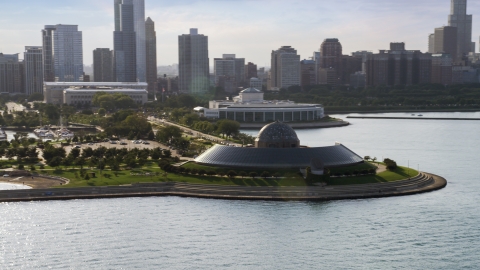 AX0002_087.0000041F - Aerial stock photo of The Adler Planetarium and Astronomy Museum, Downtown Chicago in the background, Illinois