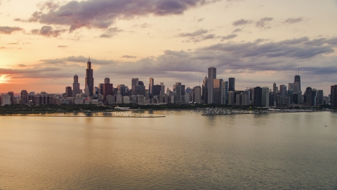 AX0003_030.0000193F - Aerial stock photo of The Downtown Chicago skyline at sunset seen from Lake Michigan, Illinois