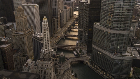 AX0003_038.0000097F - Aerial stock photo of The Chicago River between Mather Tower and Trump Tower at sunset, Downtown Chicago, Illinois