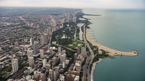 AX0003_053.0000251F - Aerial stock photo of Lake Shore Drive by apartment buildings and Lincoln Park on a cloudy day at sunset, North Chicago, Illinois