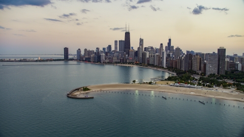 AX0003_072.0000303F - Aerial stock photo of North Avenue Beach and Downtown Chicago skyline at twilight, Illinois