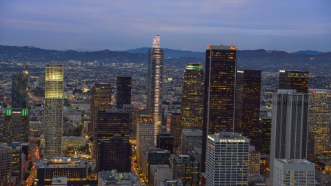 AX0158_047.0000110 - Aerial stock photo of Wilshire Grand Center and nearby skyscrapers at twilight in Downtown Los Angeles, California
