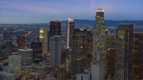 AX0158_048.0000259 - Aerial stock photo of A group of skyscrapers at twilight in Downtown Los Angeles, California