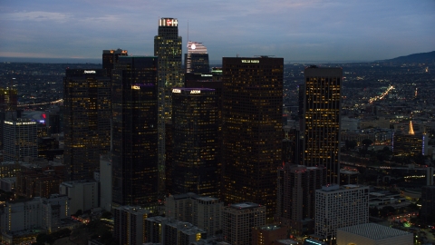AX0158_049.0000209 - Aerial stock photo of Skyscrapers at twilight in Downtown Los Angeles, California