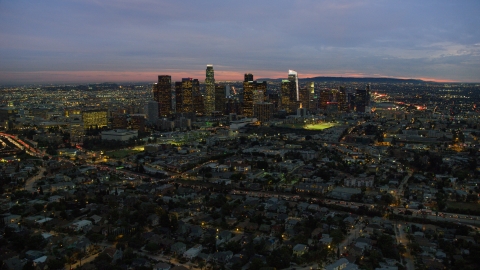 AX0158_056.0000456 - Aerial stock photo of The Downtown Los Angeles, California skyline seen from Echo Park Lake at twilight