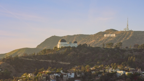AX0162_052.0000333 - Aerial stock photo of Griffith Observatory with the Hollywood Sign in the background in Los Angeles, California