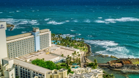 AX101_004.0000122F - Aerial stock photo of Caribe Hilton Hotel oceanside resort in the Caribbean, San Juan, Puerto Rico