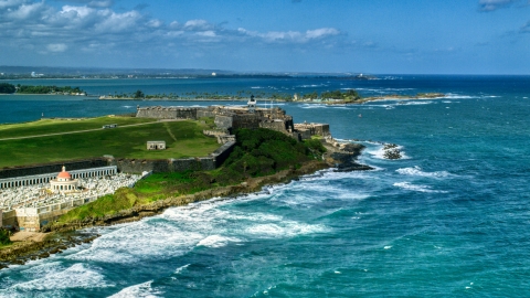 AX101_011.0000000F - Aerial stock photo of Historic fort on the coast by clear blue water, Old San Juan, Puerto Rico