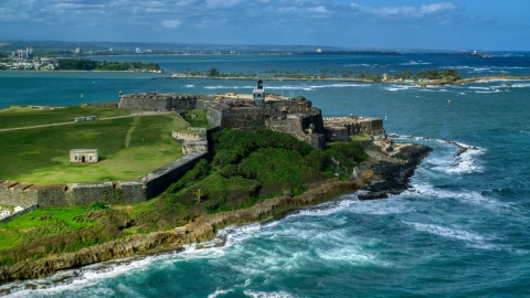AX101_011.0000142F - Aerial stock photo of Historic Fort San Felipe del Morro on the coast of Old San Juan, Puerto Rico