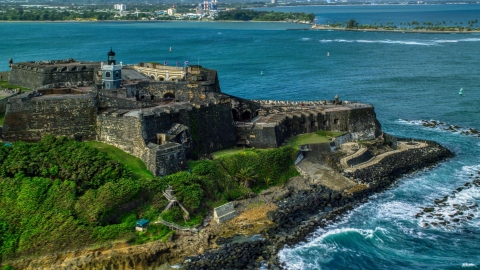 AX101_012.0000125F - Aerial stock photo of Historic fort along the coast with clear blue water, Old San Juan Puerto Rico