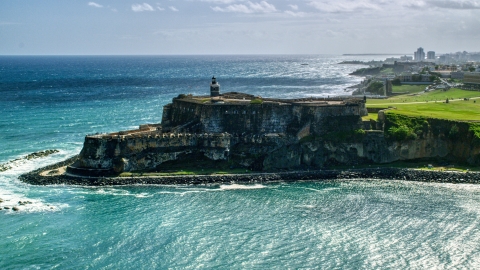 AX101_015.0000162F - Aerial stock photo of Fort San Felipe del Morro overlooking the sea in Old San Juan, Puerto Rico
