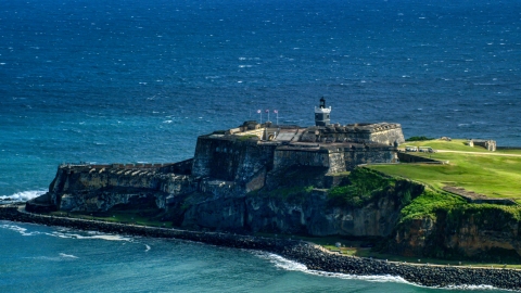 AX101_019.0000203F - Aerial stock photo of Castillo San Felipe del Morro by blue Caribbean waters, Old San Juan, Puerto Rico