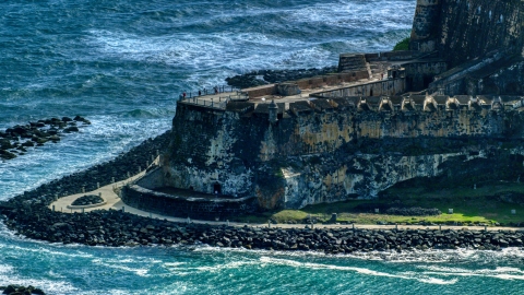 AX101_021.0000232F - Aerial stock photo of Historic Caribbean fort with tourists, Old San Juan, Puerto Rico
