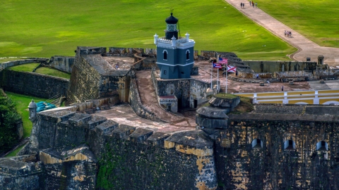 AX101_023.0000208F - Aerial stock photo of Historic Caribbean fort and lighthouse, Old San Juan, Puerto Rico