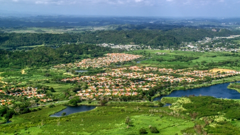 AX101_033.0000000F - Aerial stock photo of Rural neighborhoods among trees and grassy areas, Dorado, Puerto Rico 