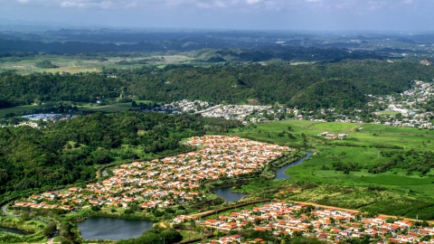 AX101_034.0000000F - Aerial stock photo of Rural neighborhoods near forests, Dorado, Puerto Rico Day 