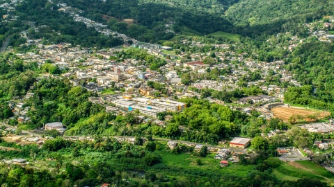 AX101_046.0000180F - Aerial stock photo of The small town of Ciales, surrounded by trees in Puerto Rico 