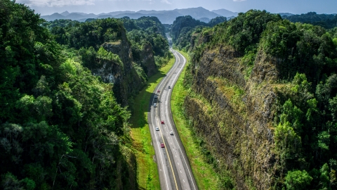 AX101_083.0000200F - Aerial stock photo of A highway through lush green mountains, Karst Forest, Puerto Rico