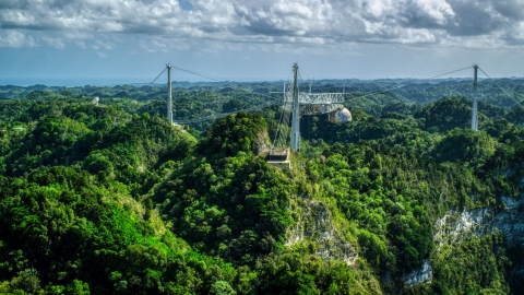 AX101_110.0000247F - Aerial stock photo of A view over lush jungle of the Arecibo Observatory, Puerto Rico