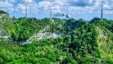 AX101_114.0000000F - Aerial stock photo of Top of the Arecibo Observatory seen above karst mountains, Puerto Rico